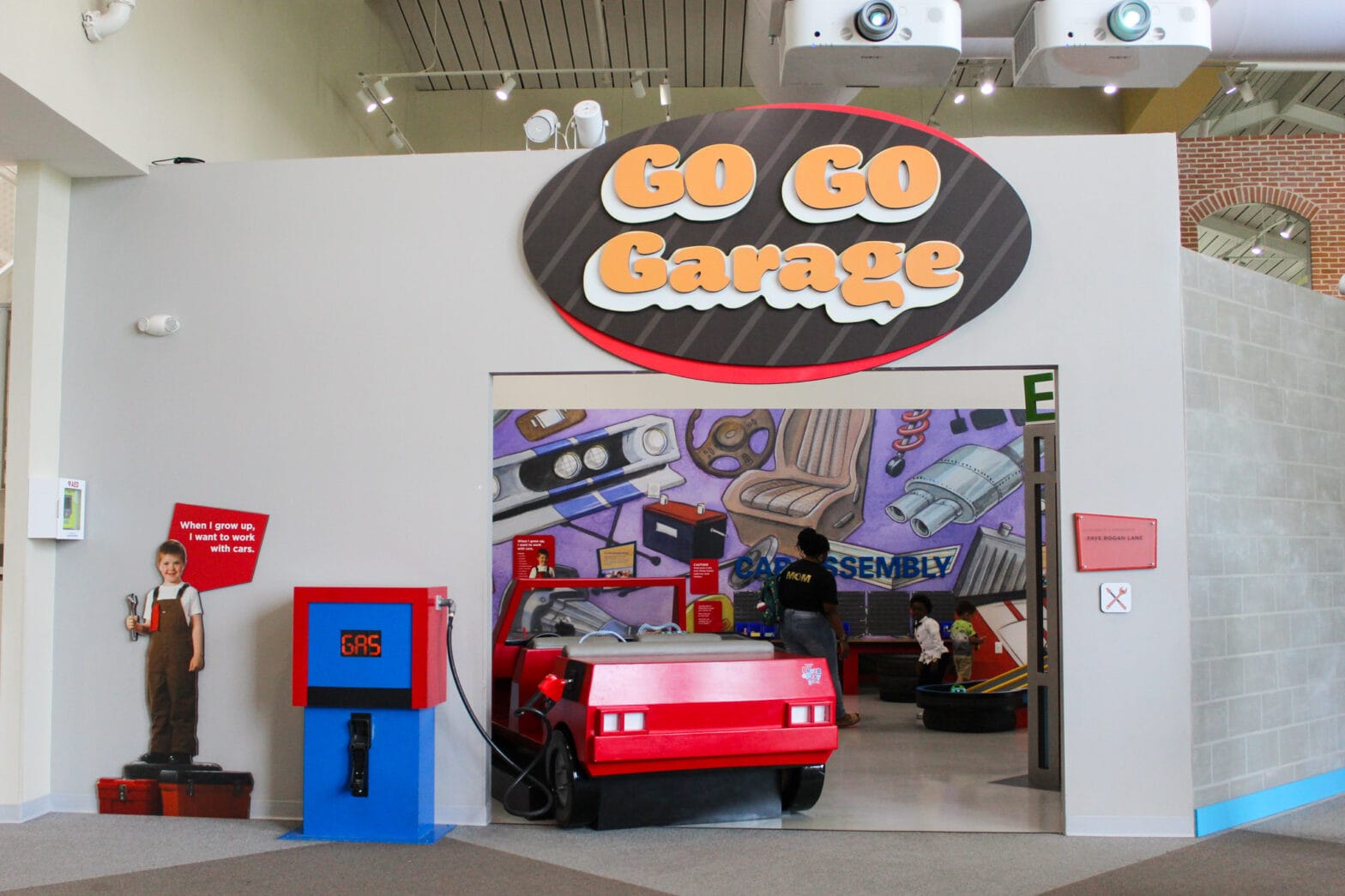 The entrance to the Go Go Garage with a fake gas pump and a life size toy car.