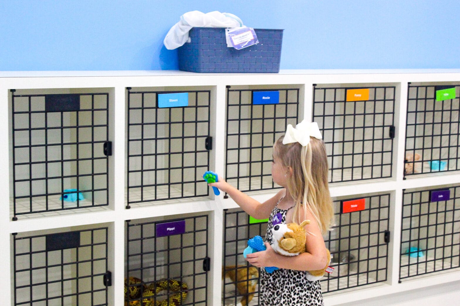 A little girl opening up the toy crates where the toy animals are located