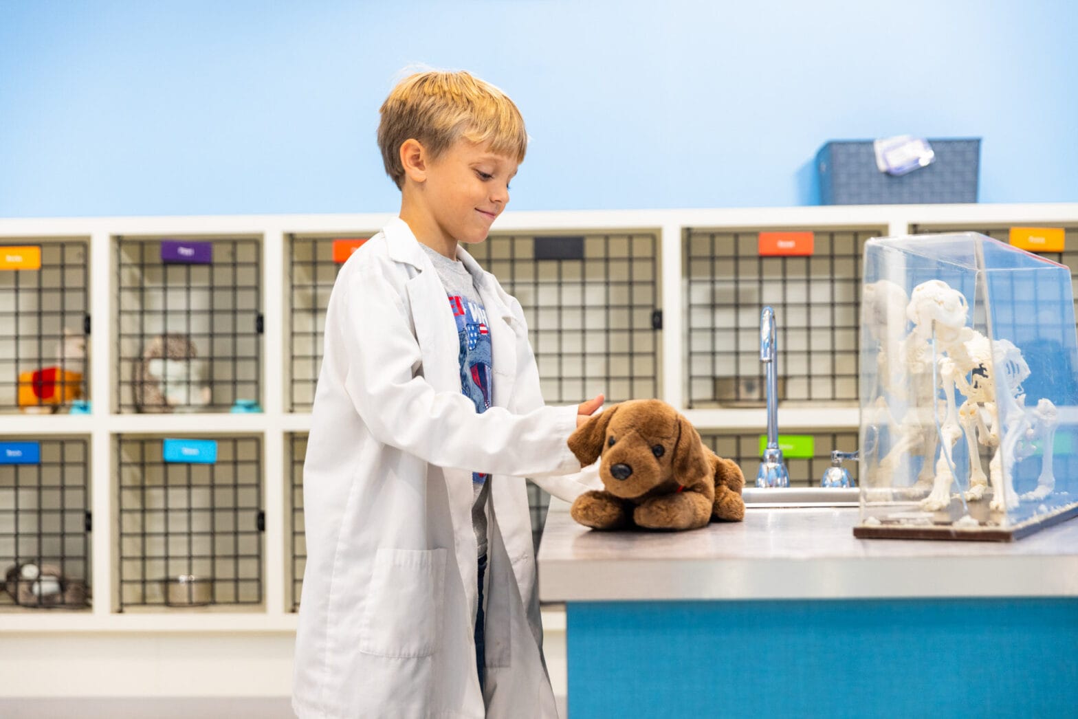 A little boy doing a play check up on a toy dog