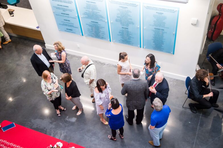 A group of people talking inside the Knock Knock Museum