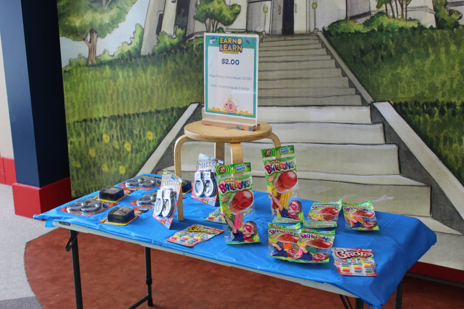 Table in the Earn & Learn Shop selling items for children to purchase with the coins they earned.