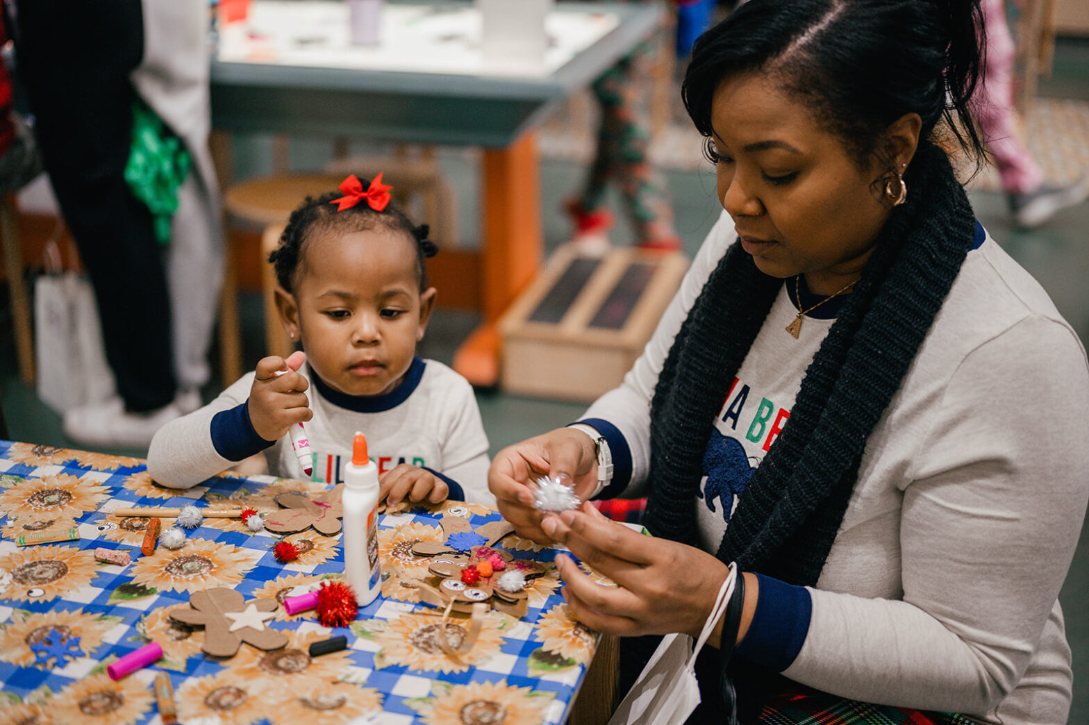 a mother and daughter make gingerbread ornaments in knock knock's art garden
