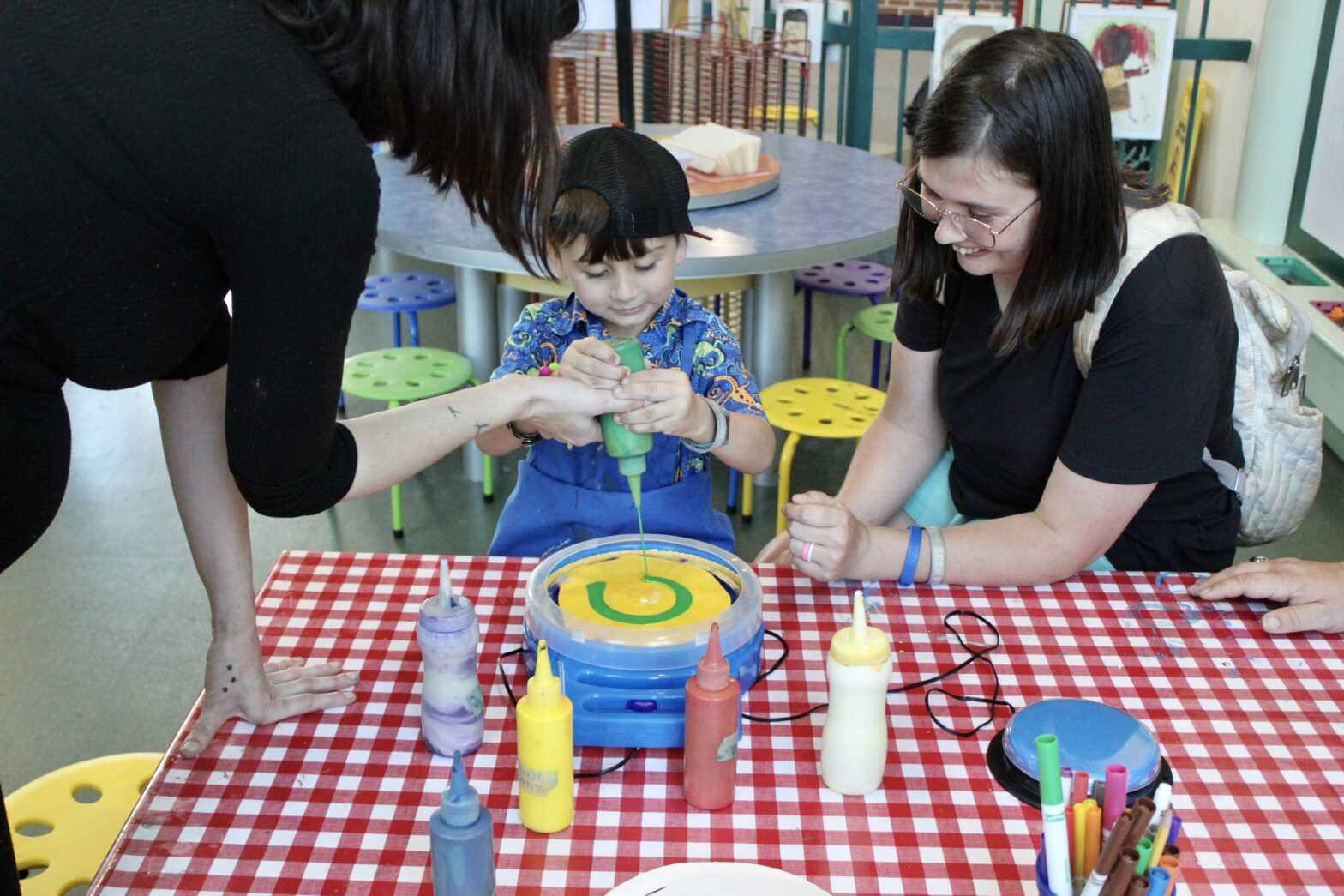 Child paints at Knock Knock Children's Museum.