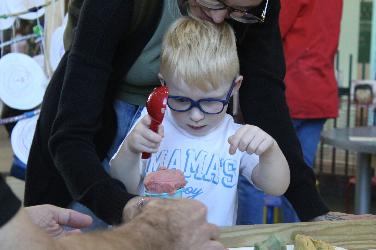 A boy plays with play dough in Knock Knock maker shop
