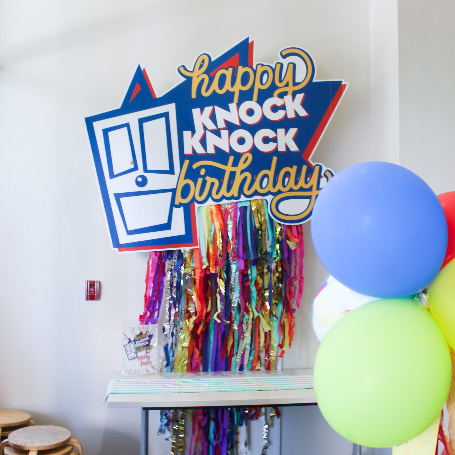 the Happy Knock Knock Birthday sign hangs in knock knock's birthday party room