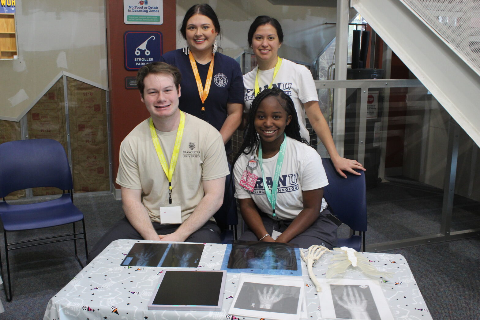 fran. u students pose at their table